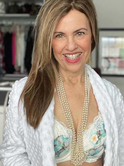 Woman in a white robe over a floral organic cotton bra